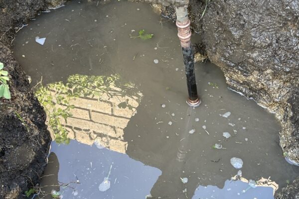 Burst water pipe keogh plumbing 2 Burst copper water pipe surrounded by pooling water in an excavated area