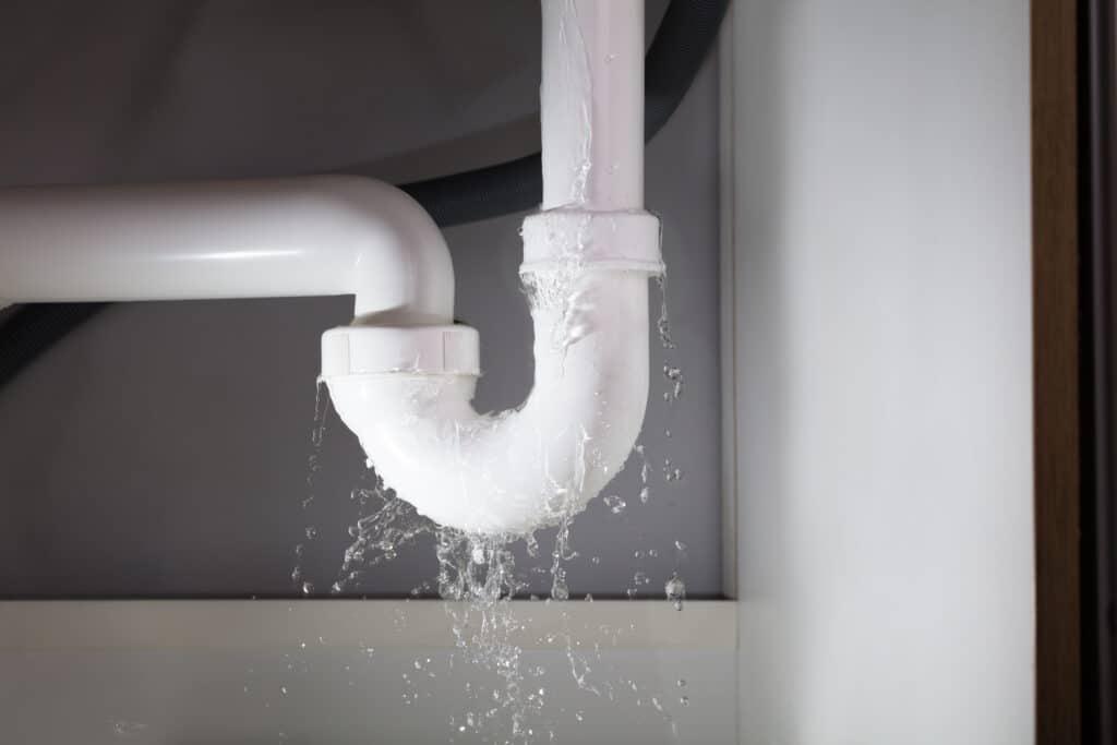 Close-up,Of,Water,Is,Leaking,From,The,White,Sink,Pipe water leaking from a white sink pipe