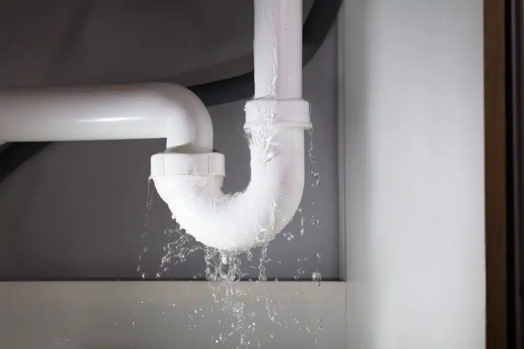 Close-up,Of,Water,Is,Leaking,From,The,White,Sink,Pipe water leaking from a white sink pipe
